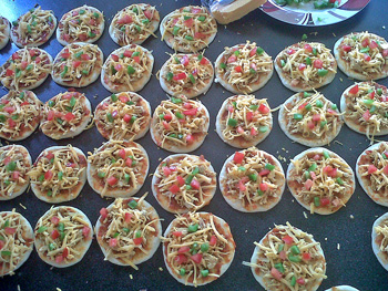 A tray of mini pizza with toppings